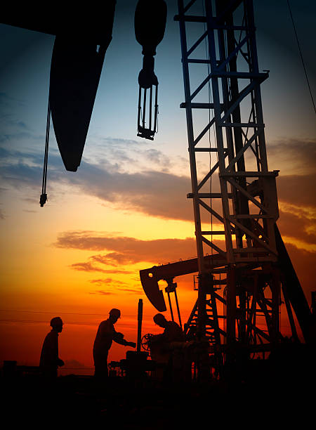 istock oil field, the oil workers are working 488574814