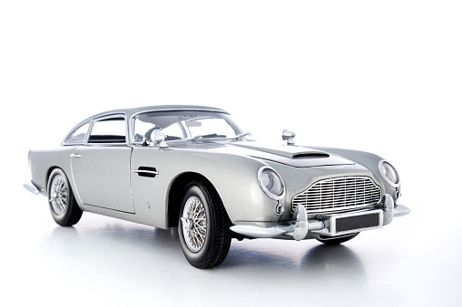 Beaconsfield, UK - September 15, 2015: A model of Aston Martin's iconic DB5 against a bright white background. Released in 1963, it found global fame as the gadget-laden transport of the world's most famous secret agent, James Bond.