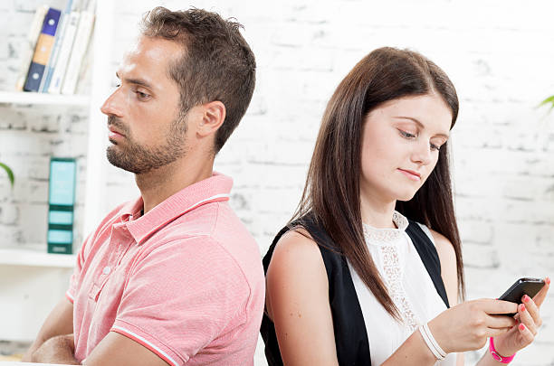 istock young couple sitting back to back 488574958