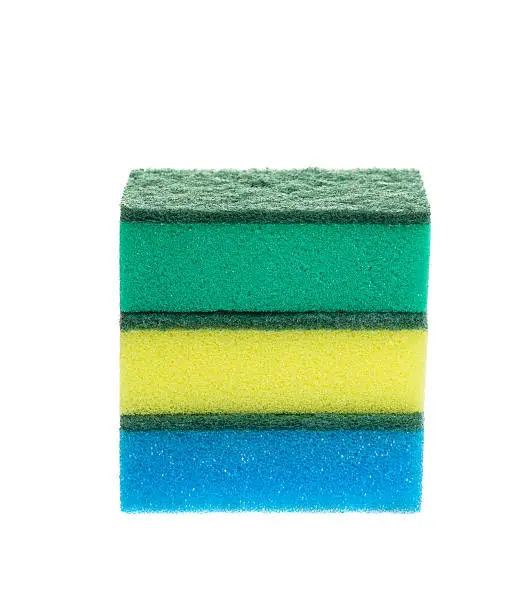 Three colored sponges for dishwashing isolated on white background, studio shot