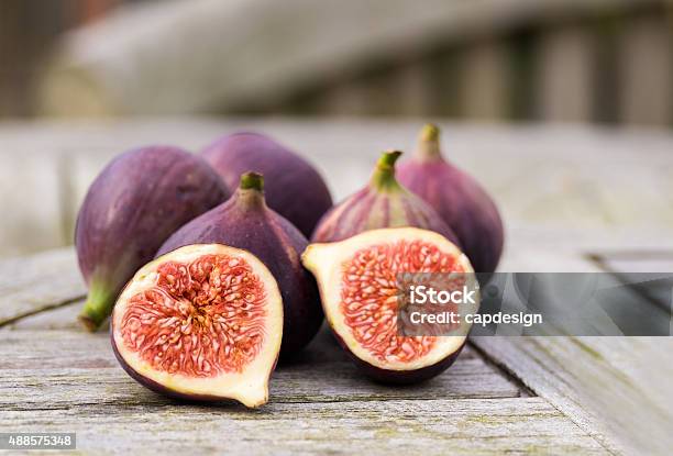 Figs On A Wooden Table Outside Stock Photo - Download Image Now - 2015, Chopped Food, Color Image