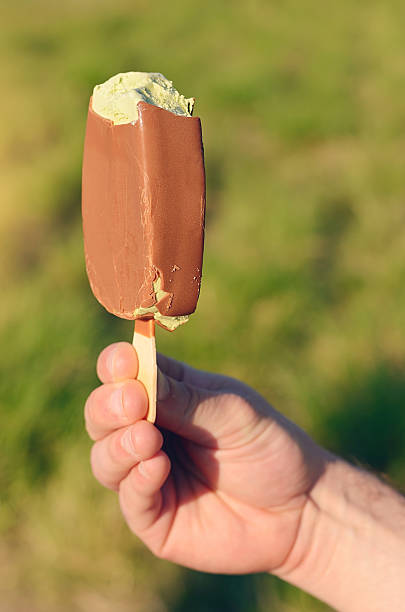 istock Male hand holding a ice lolly 488575888
