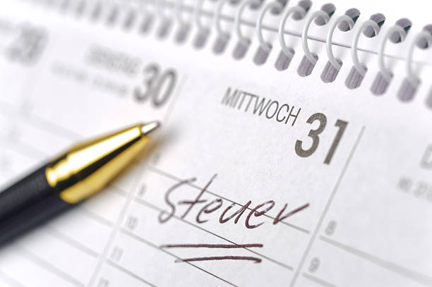 tax-day in germany memo in calendar for tax-day in germany tax season photos stock pictures, royalty-free photos & images