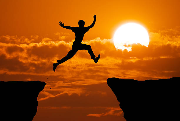 Man jump through the gap. stock photo