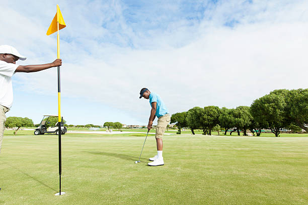 istock African golfer taking his last putt. 488576297