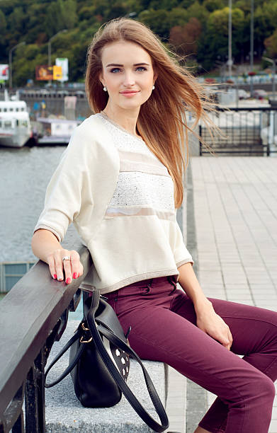 istock Tender young woman sitting on the pier 488576878