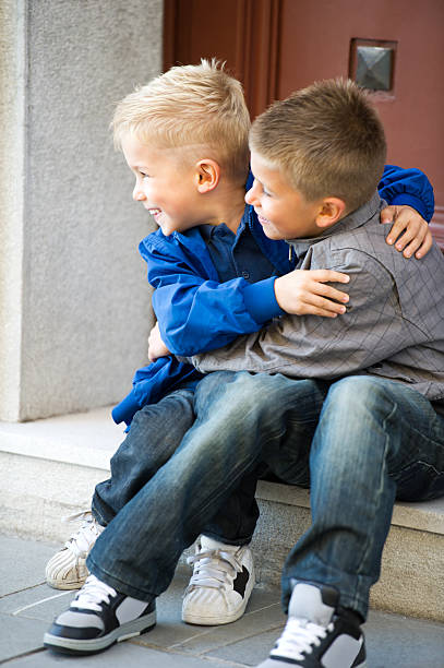istock Happy Brother Sitting On Door Steps 488577201
