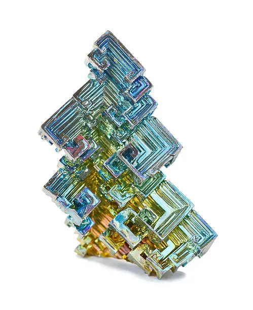 Skeletal crystals of bismuth with tarnish on a white background