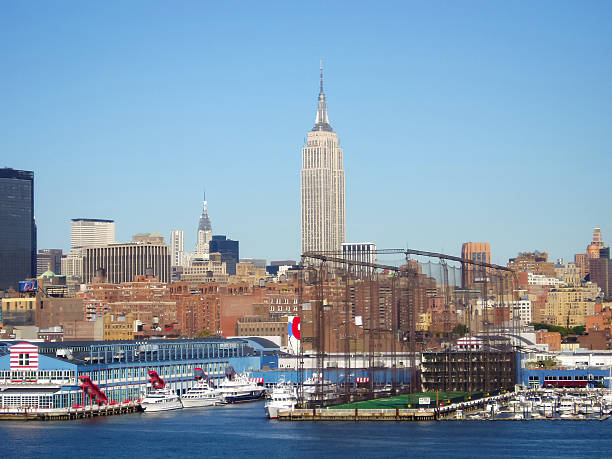 New York City, USA. - September 10th, 2003 : A view of the dock with the Golf Club and Sports Center at Chelsea Piersthe and Empire State Building with other residential skyscrapers in Midtown Manhattan in New York City, USA.