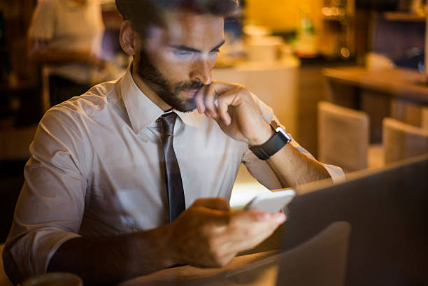 istock Man with mobile phone in coffee shop 488577778