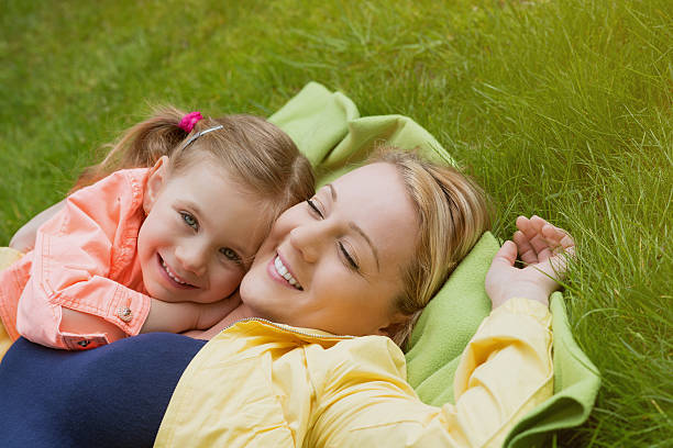 istock happy family laying at grass 488578567