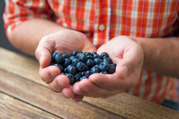 istock handful of blueberries 488578576