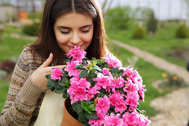 istock woman smelling pink flowers 488578829