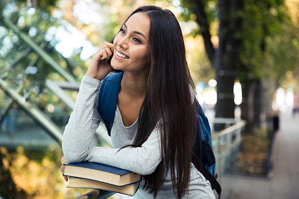 istock Female student talking on the phone outdoors 488580482