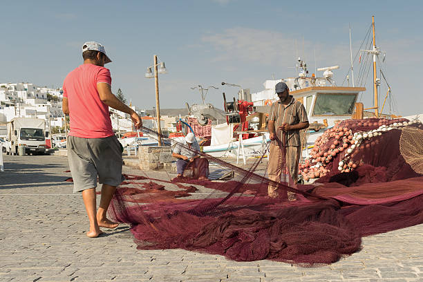 Close up a worker is knitting fishing net, a traditional work of Vietnamese, Nha Trang, Khanh Hoa province, central Vietnam