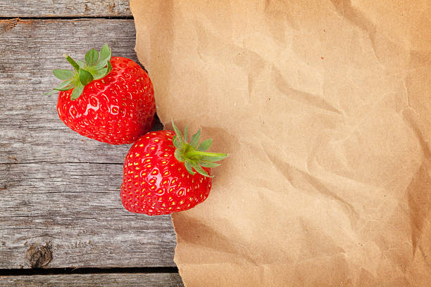 istock Ripe strawberries over wooden table background 488593121