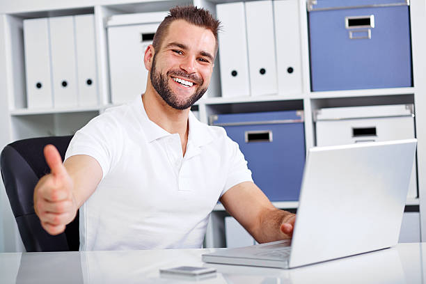 istock Business man working on laptop and making the ok gesture 488593843