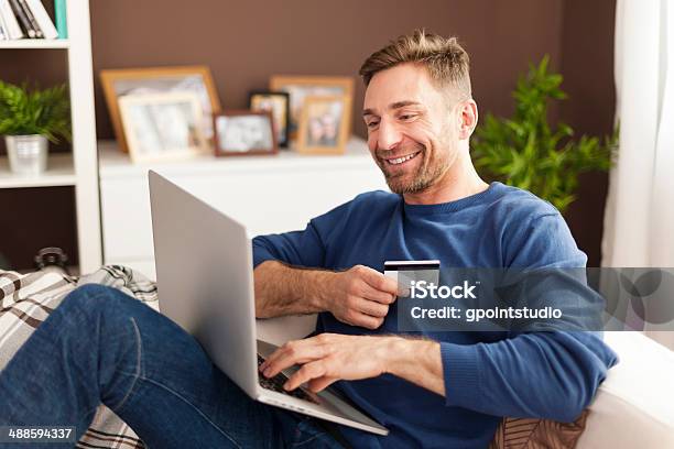 Smiling Man During Online Shopping At Home Stock Photo - Download Image Now - Online Shopping, Adult, Adults Only