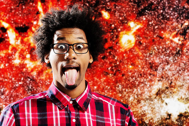 istock Wild-eyed, afro-haired young astrophysicist mimics Albert Einstein, sticking out tongue 488594485