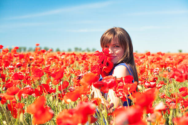 istock Girl with poppies 488596016