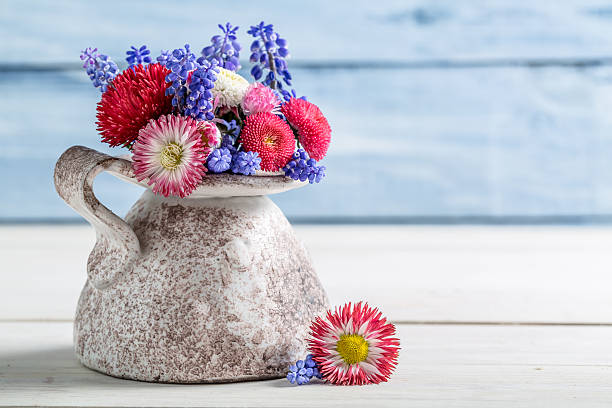 istock Blue and red daisy flower in vase 488596457