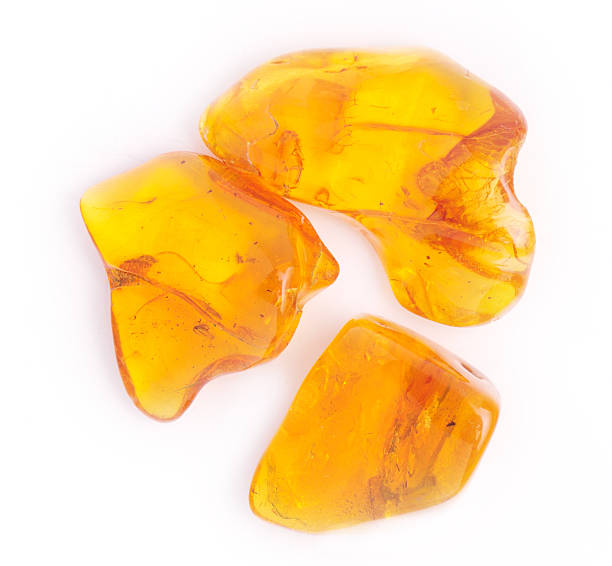 istock amber gemstone on white. Soft focus, photo toned 488597080