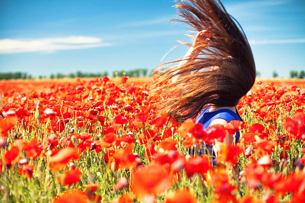 istock Girl with poppies 488597406