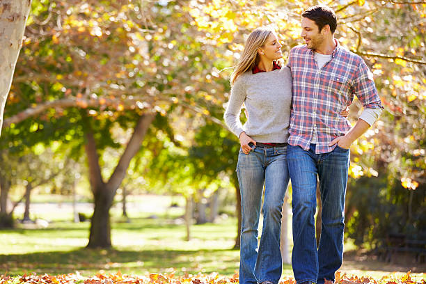 istock Romantic Couple Walking Through Autumn Woodland 488597799