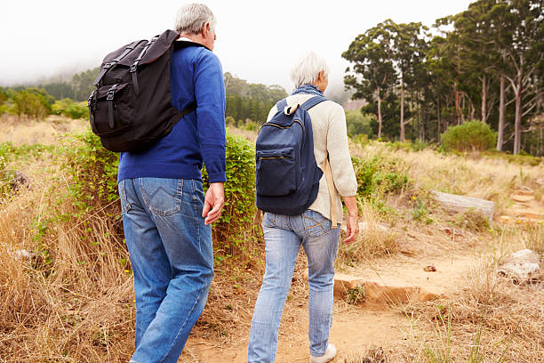 istock Senior couple walking together in a forest, close-up back view 488597982
