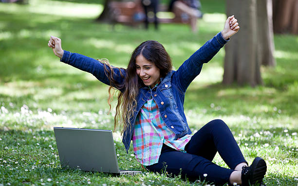 istock young woman surfing the internet in a park 488598611