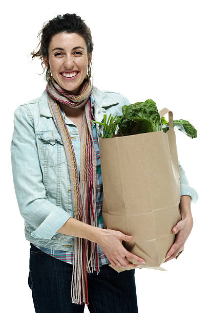 istock Cheerful woman holding vegetable bag 488598723