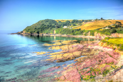 Talland Bay between Looe and Polperro Cornwall England UK in HDR bright and vivid colours on a beautiful blue sky sunny day