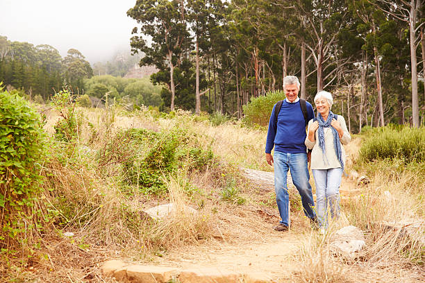 istock Senior couple walking in a forest towards the camera 488599306
