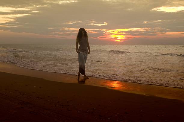istock Woman Walking Beach At Sunrise 488601066