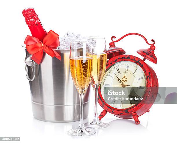 Two Champagne Glasses Bottle In Cooler And Clock Stock Photo - Download Image Now - 2015, Alarm Clock, Alcohol - Drink