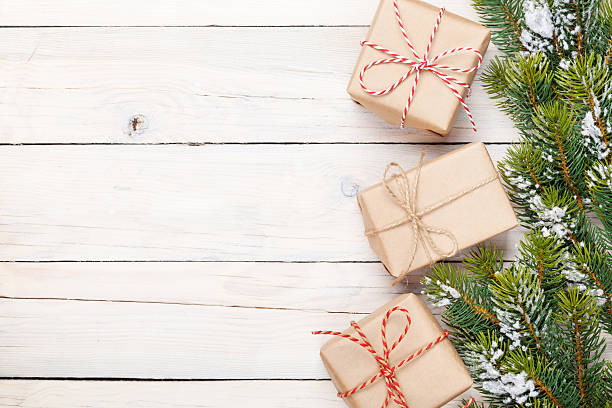 istock Christmas fir tree with snow and gift boxes 488603144