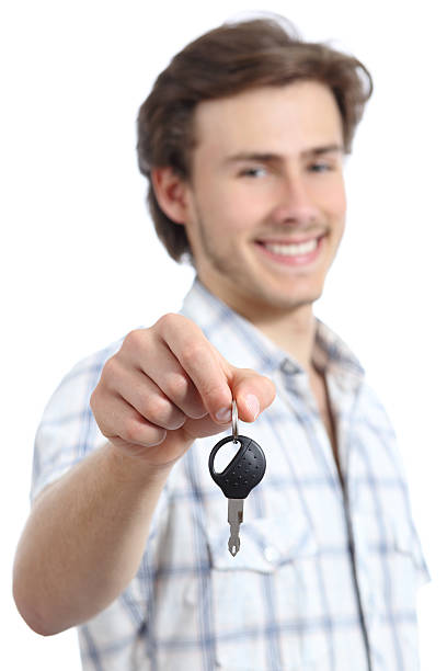 istock Young man holding a rental car key 488603612