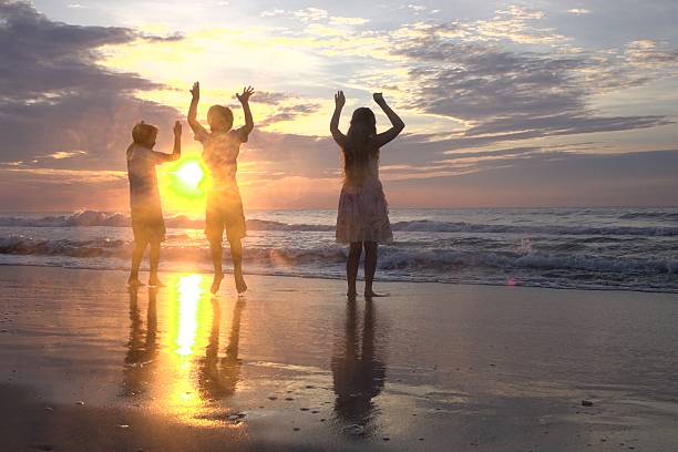 istock Kids On Beach At Sunrise 488611496