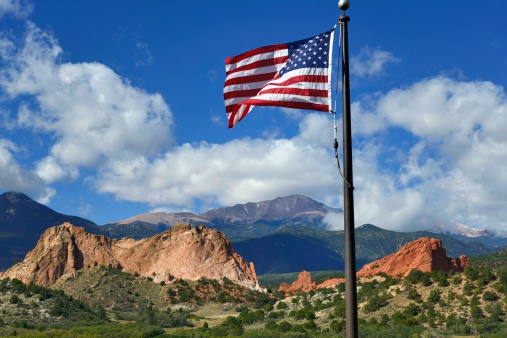 An American flag with the beautiful Garden of the Gods Park in the background in Colorado Springs.