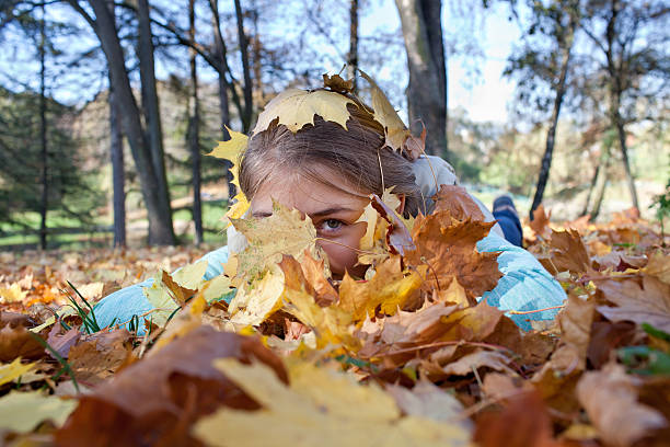 istock Girl in the Autumn leaves 488612324
