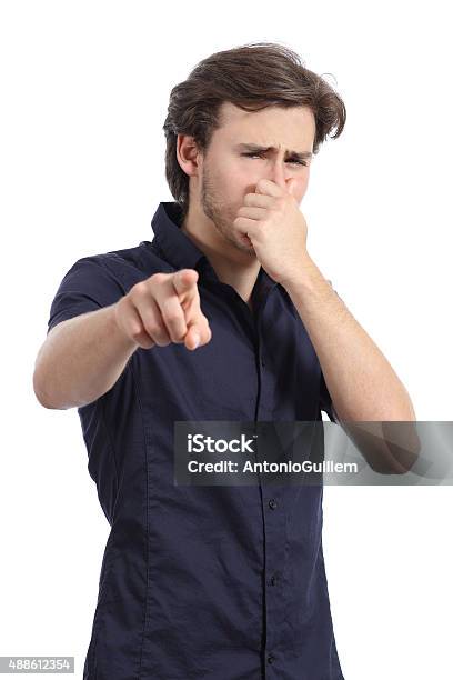 Man Pointing You With Hand Holding Nose Because Bad Stink Stock Photo - Download Image Now