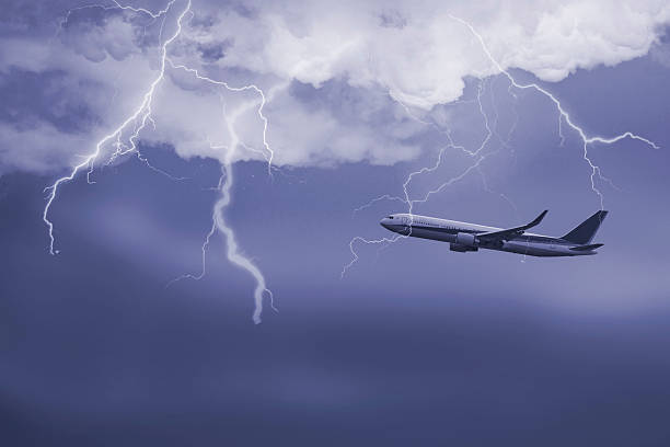 jet travelling through stormy sky Passenger airplane travelling through sky against stormy bolt cloudscape wow airlines stock pictures, royalty-free photos & images