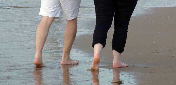 istock Couple Walking On The Beach After Lunch 488614252