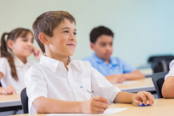 istock Little boy smiling in private elemenatary school class 488614742