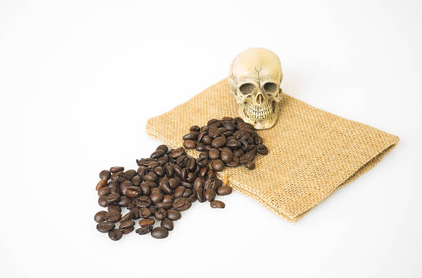 istock Coffee beans on sack with skull on a white background 488614756