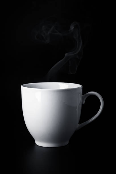istock white cup with hot liquid and steam on black 488615903