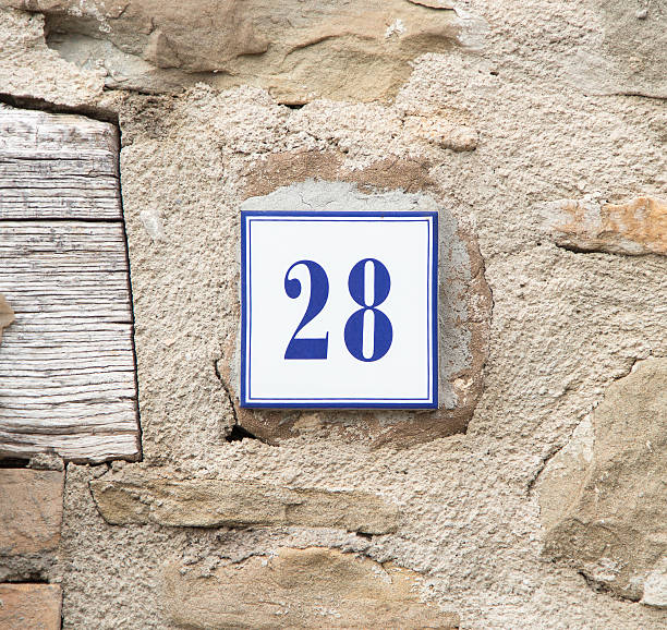 istock Number twenty eight on the grey stone wall 488616960
