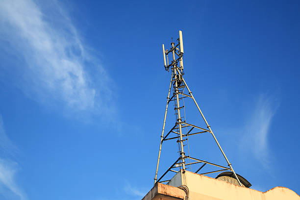 istock Cell Phone Tower on building against blue sky 488617643