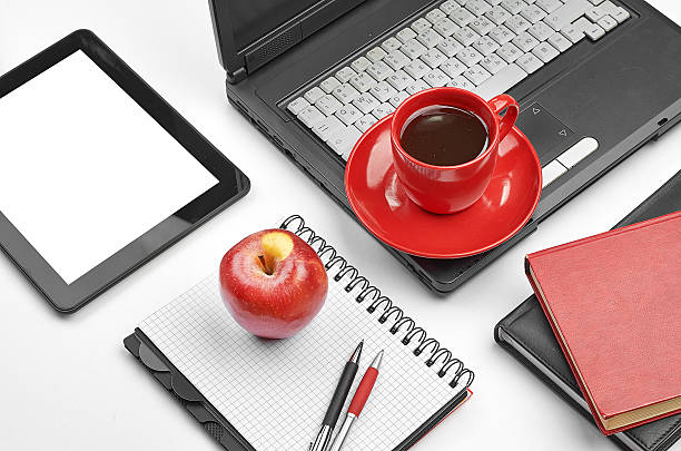 istock Laptop and office supplies on white 488617881