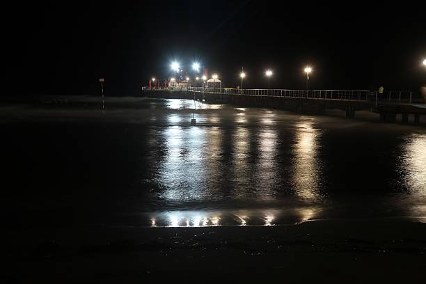 istock Bridge in the sea at night 488623618